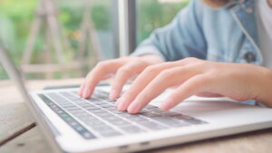 business-freelance-asian-woman-working-doing-projects-sending-email-laptop-computer-while-sitting-table-cafe-min daycare website design